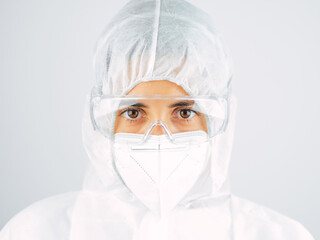 Caucasian woman doctor in uniform, medical cap and mask, close-up portrait.