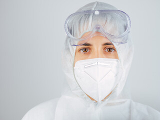 Caucasian woman doctor in uniform, medical cap and mask, close-up portrait.