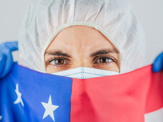 American woman doctor in uniform, medical cap and mask, close-up portrait.