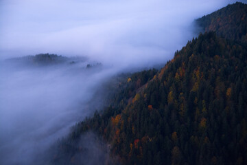 Foggy sunrise in mountains, colorful forest in Trzy Korony, Malopolskie, Poland.