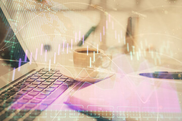 Double exposure of financial chart drawing and desktop with coffee and items on table background. Concept of forex market trading