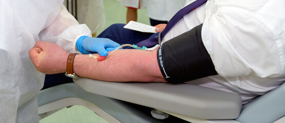 Blood donor survivor of coronavirus infection. Hand, analysis, test tubes.