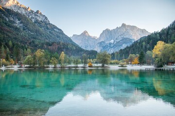 Calm evening with mirror reflections at Lake Jasna with Triglav mountains in the background in Slovenia