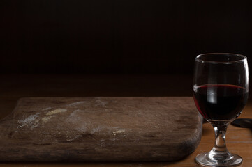 Wood table background and wine cup, side view, selective focus