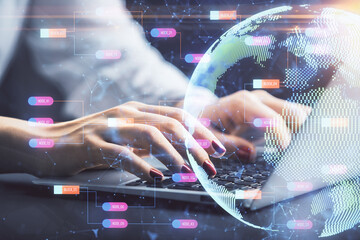 Double exposure of woman hands working on computer and world map hologram drawing. International technology business concept.