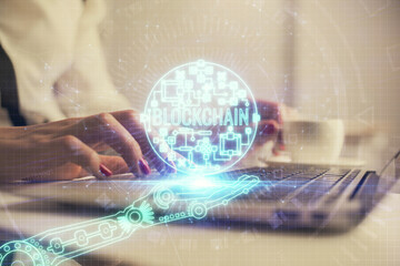 Double exposure of woman hands typing on computer and crypto market theme hologram drawing....
