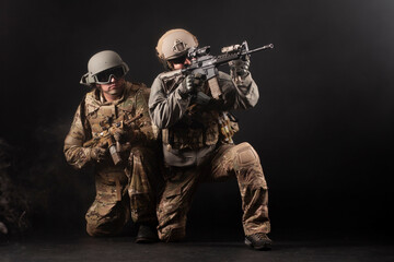 American special forces on special missions at night, two rangers in military equipment and weapons aiming in the dark