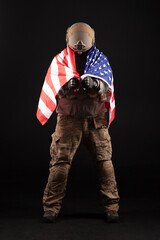 American special forces against a dark background, a soldier in military equipment holds weapons and the flag of the United States of America, elite troops