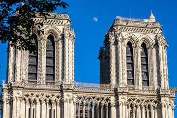Paris, France - June 1, 2020: Beautiful view of the Notre-Dame Cathedral with a faint moon above it...