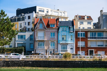 beautiful houses with tiled roofs on the street of a small town. sunny day. France. Normandy.