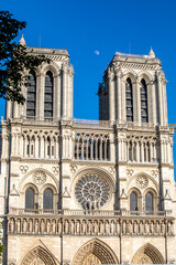 Fototapeta na wymiar Paris, France - June 1, 2020: Beautiful view of the Notre-Dame Cathedral with a faint moon above it in Paris