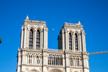 Fototapeta na wymiar Paris, France - June 1, 2020: Beautiful view of the Notre-Dame Cathedral with a faint moon above it in Paris