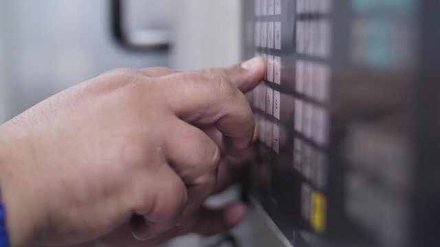 Technician programming with keyboard a  cnc machine slow motion