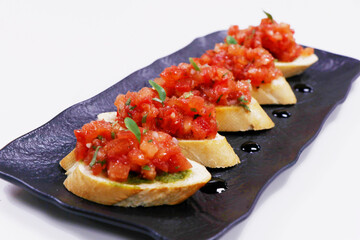classic tomato bruschetta, fresh tomato cubes marinated in olive oil and basil with bread crouton