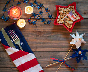 4th of July Table Setting with Rustic Wood Background providing copy space, and red white and blue...