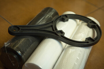 Changing filters in your home water purification system. The new filters are 5 microns, 1 micron...