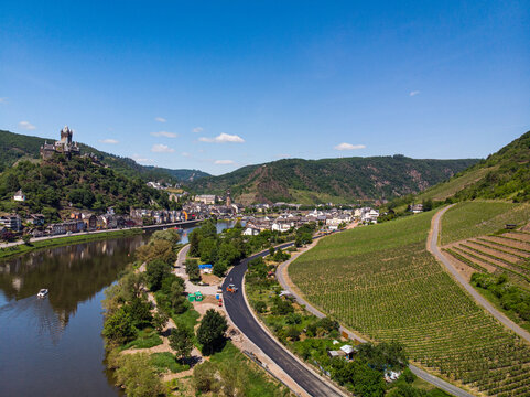 With the bike on the cycle path through the countryside along the river Moselle in Rhineland-Palatinate from Trier to Koblenz in summer