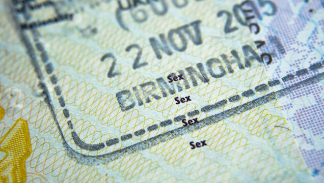 Entry stamp in passport made by immigration officer  at border and visa control at Birmingham airport in United Kingdom. Selective focus. Macro photo.
