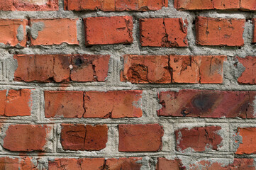 Old wall background with stained aged red bricks. abstract background close up