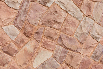 Decorative stone wall in pink tones, for use in background