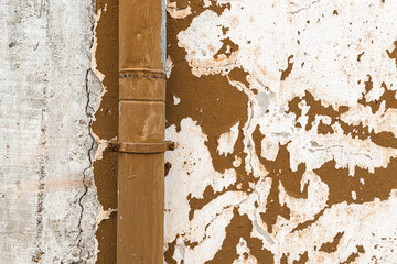 Old vibrant orange wall aged pipe exterior weathered paint chapped surface detail
