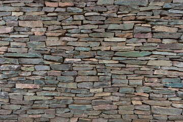 Decorative stone wall in various shades and sober colors, for background use.
