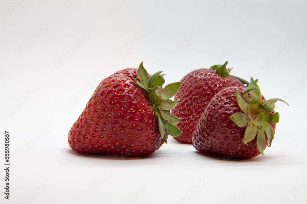 Wall mural ripe juicy strawberries closeup isolated on white background