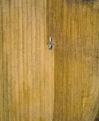Aerial Overhead View of Farm Equipment Plowing Agricultural Field