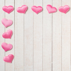 Pretty Pink Valentines Day hearts on White wood Boards Background with a Shabby Chic Style.  It's a square with copy space in the center.