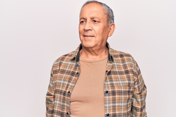 Senior man with grey hair wearing casual shirt looking to side, relax profile pose with natural face and confident smile.