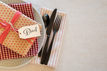 Table Place Setting for a Man or Boy for a Birthday Party or Father's Day Celebration Dinner and background room or space for copy, text or words.  Horizontal with Flay layout and above view