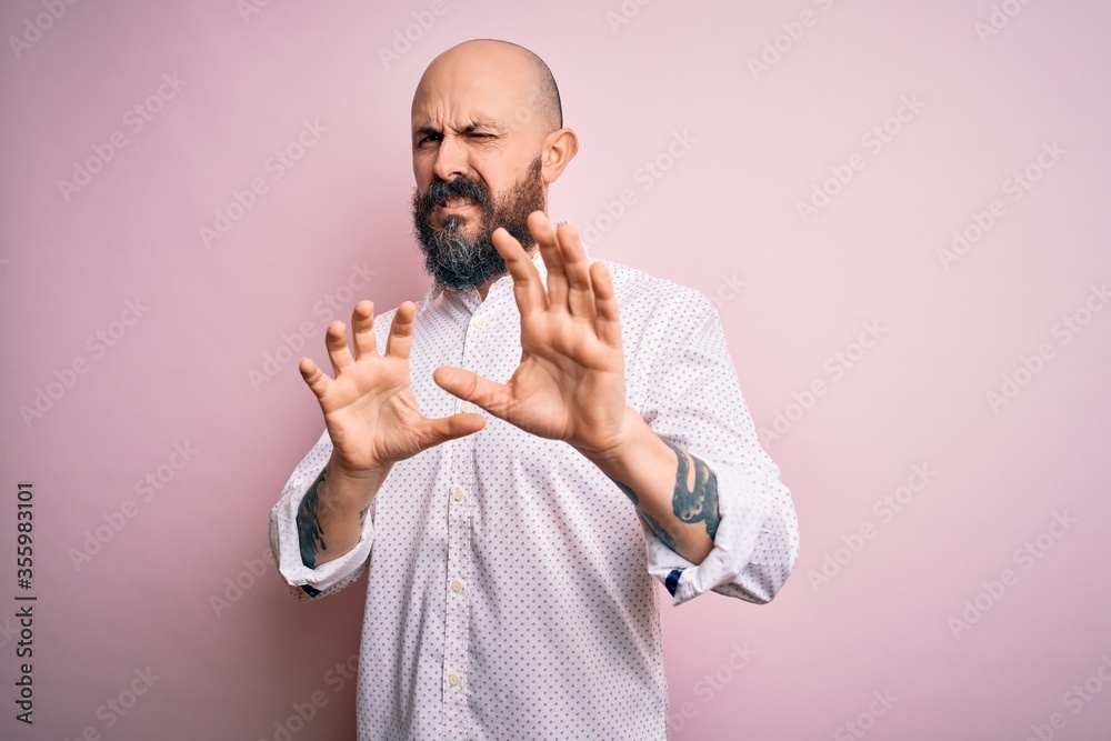 Sticker handsome bald man with beard wearing elegant shirt over isolated pink background disgusted expressio