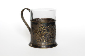 vintage glass in metal cup holder on a white background