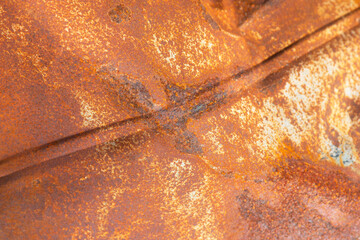 Background with dented smooth rusty red and blue metal