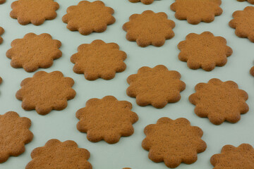 Swedish thin ginger cookies in rows on green background