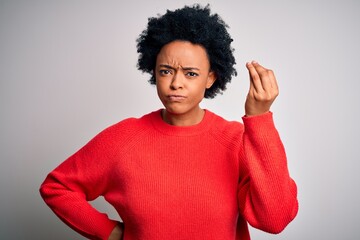 Fototapeta na wymiar Young beautiful African American afro woman with curly hair wearing red casual sweater Doing Italian gesture with hand and fingers confident expression
