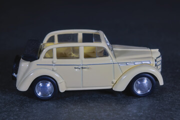 Children's toy car white on a dark background close-up.