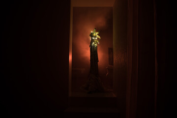 Silhouette of an unknown shadow figure on a door through a closed glass door. The silhouette of a human in front of a window at night. Scary scene halloween concept of blurred silhouette of maniac.