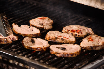 Grilled meatloaf with fruits inside. Meat on the girll. Cooking food.