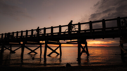 Cyclists at sunset on Taylor Dock, Bellingham