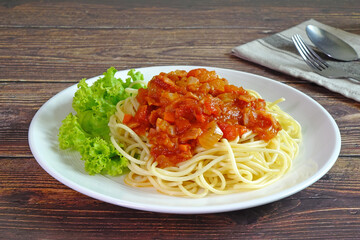 Spaghetti with bacon in tomato sauce. Selective focus