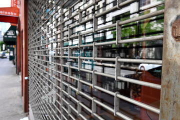 Close up of grate pattern of iron and steel security gate on store front