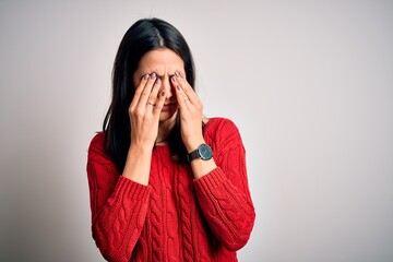 Young brunette woman with blue eyes wearing casual sweater over isolated white background rubbing eyes for fatigue and headache, sleepy and tired expression. Vision problem