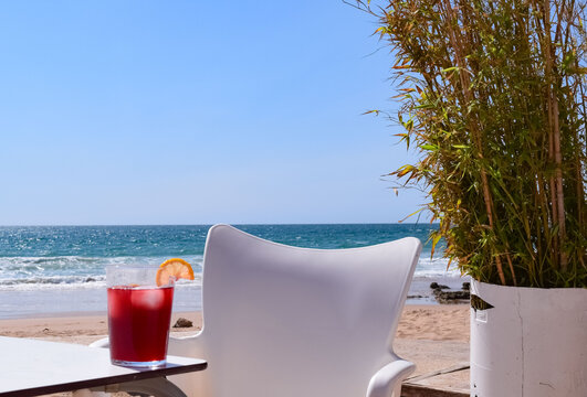 Red sangria cocktail alcohol drink with an orange on a beach bar on the Zahora beach in Cadiz, Andalusia