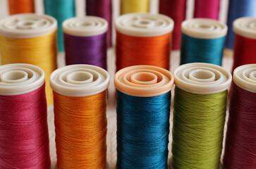 A close up of brightly coloured threads on cotton reels. Craft image or sewing image.