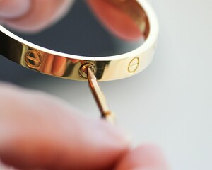 close up of hand holding cartier