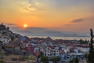 Fototapeta na wymiar Greek old city Nafplion seen from above in a colorful evening sky sunset dramatic sky