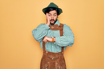 Young handsome man wearing tratidional german octoberfest custome for Germany festival Looking at...