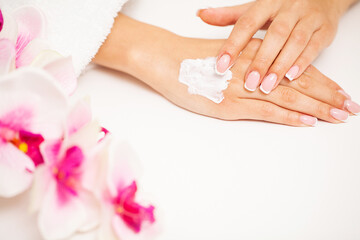 Woman applies moisturizer cream for hand skin care