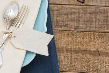 Pretty and Simple arrangement of a Table Place Setting with Fork, Spoon, White Napkin on a Teal...